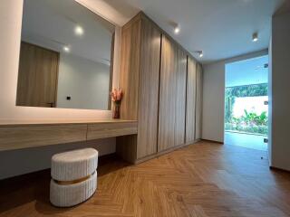 Stylish hallway with wooden flooring and built-in closets