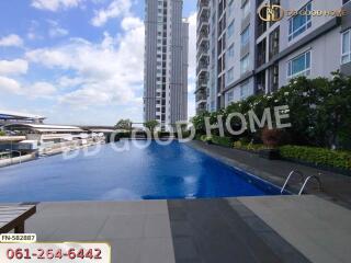 Swimming pool area with modern residential buildings in the background