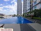 Swimming pool area with modern residential buildings in the background