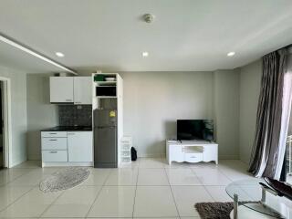 Modern living area with kitchenette and television
