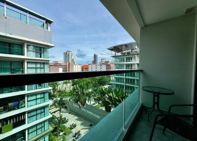 View from the balcony showing nearby buildings and outdoor greenery