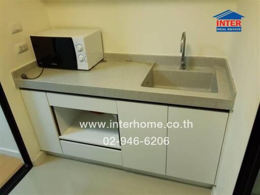 Compact kitchen with microwave and sink