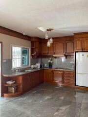 Spacious kitchen with wooden cabinets and modern appliances