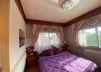 Cozy bedroom with purple bedding and natural light