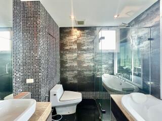 Modern bathroom with glass shower and tiled walls