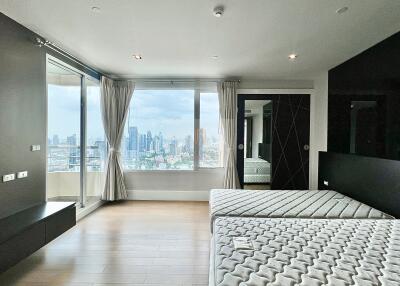 Modern bedroom with large windows and city view