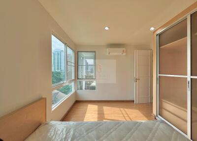 Modern bedroom with large windows and city view