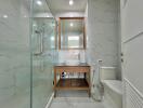 Modern bathroom with glass shower and wooden accents