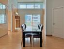 Modern dining area with large windows and wooden flooring