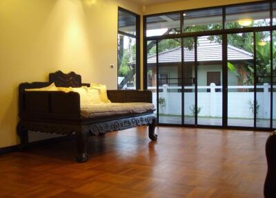 Spacious Living Area with Wooden Flooring and Large Windows