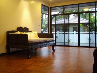 Spacious Living Area with Wooden Flooring and Large Windows