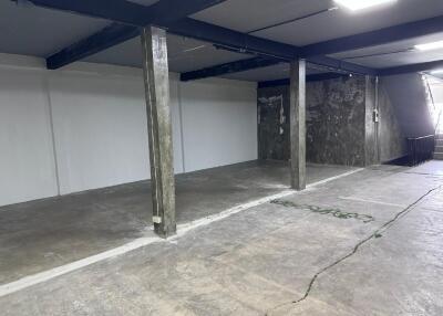 spacious basement area with concrete pillars and industrial finish