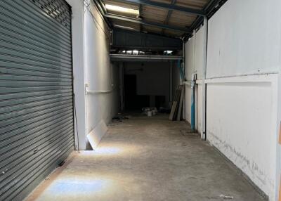 Empty garage space with closed shutter door