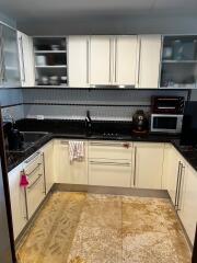 Modern kitchen with white cabinets and granite countertop