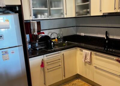 Modern kitchen with stainless steel appliances and black countertops