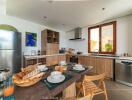 Modern kitchen with wooden cabinets, a stainless steel refrigerator, and various kitchen appliances