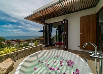 Outdoor luxury area with bathtub and ocean view