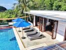 Modern outdoor area with pool and lounge chairs