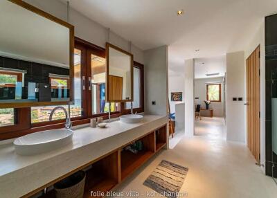 Spacious modern bathroom with large windows and double sinks