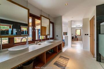 Spacious modern bathroom with large windows and double sinks