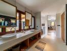 Spacious modern bathroom with large windows and double sinks