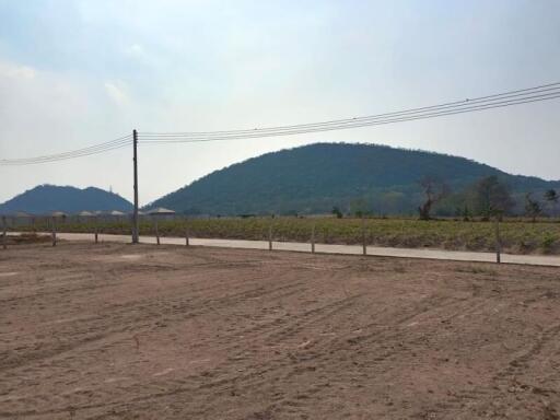 View of an empty plot of land with mountains in the background