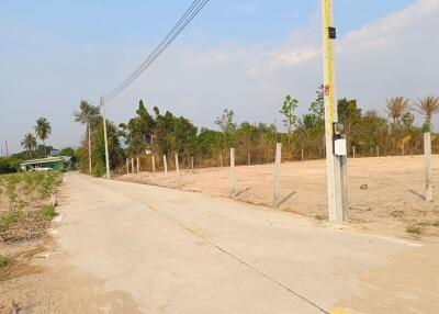 Empty plot of land with bordering fence and utility pole