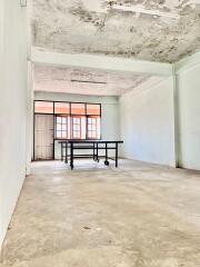 Open living area with a large window and table.