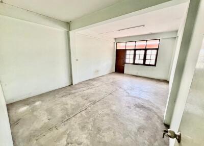 Empty living room with large window and concrete floor