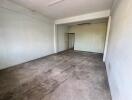 Empty room with concrete floors and plain walls