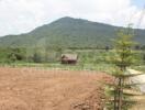 View of a remote house with a mountainous backdrop.