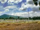 Scenic view of a rural area with mountain and clouds