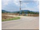 Countryside road with adjacent farmland and distant hills