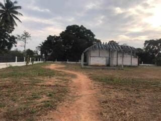 Partially constructed building on a large plot with trees