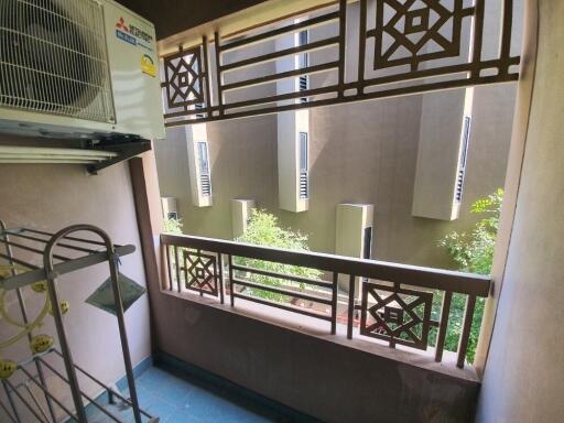 Apartment balcony with a decorative railing and outdoor air conditioning unit