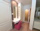 Well-lit bedroom with vanity desk and sliding door