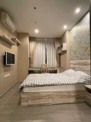 Bedroom with bed, TV, air conditioner, and window