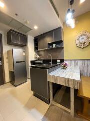 Modern kitchen with stainless steel appliances and a small dining area