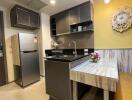 Modern kitchen with stainless steel appliances and a small dining area