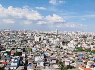 Aerial view of a cityscape with buildings under a clear blue sky