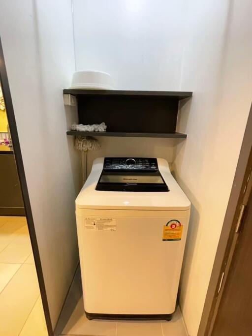 Compact laundry area with a top-loading washing machine