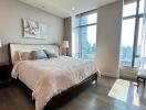 Spacious modern bedroom with large windows and city view