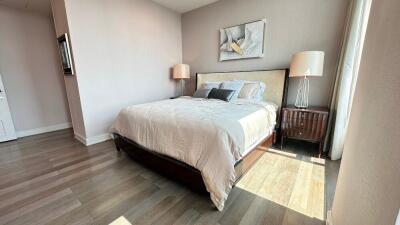 Modern bedroom with wooden floors and natural light