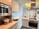 A modern kitchen with integrated appliances and dining area