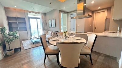 Modern dining area adjacent to a cozy living room with natural light