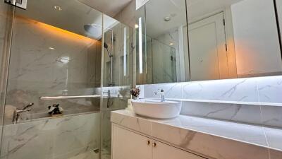 Modern bathroom with a glass-enclosed shower and sleek vanity