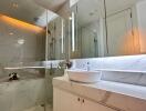 Modern bathroom with a glass-enclosed shower and sleek vanity