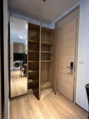 Hallway with open wooden closet and mirror