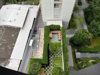 Aerial view of modern apartment complex with greenery and rooftop gardens