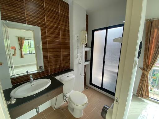 Modern bathroom with sink, toilet, and shower